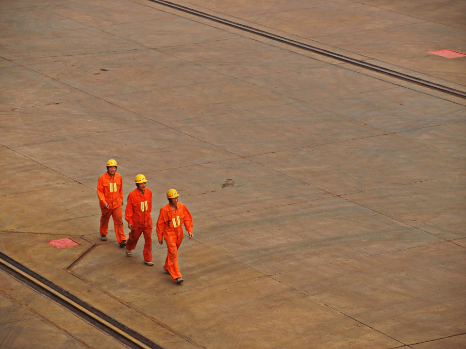 A construction crew in hard hats and safety gear on site